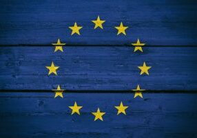 Bright Europe National Flag on a Wooden Background. 